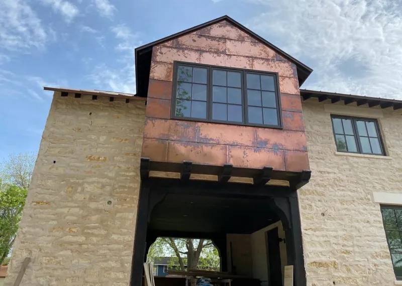 Copper metal panel facade on a stone building for Skylight Installation in Fox Lake